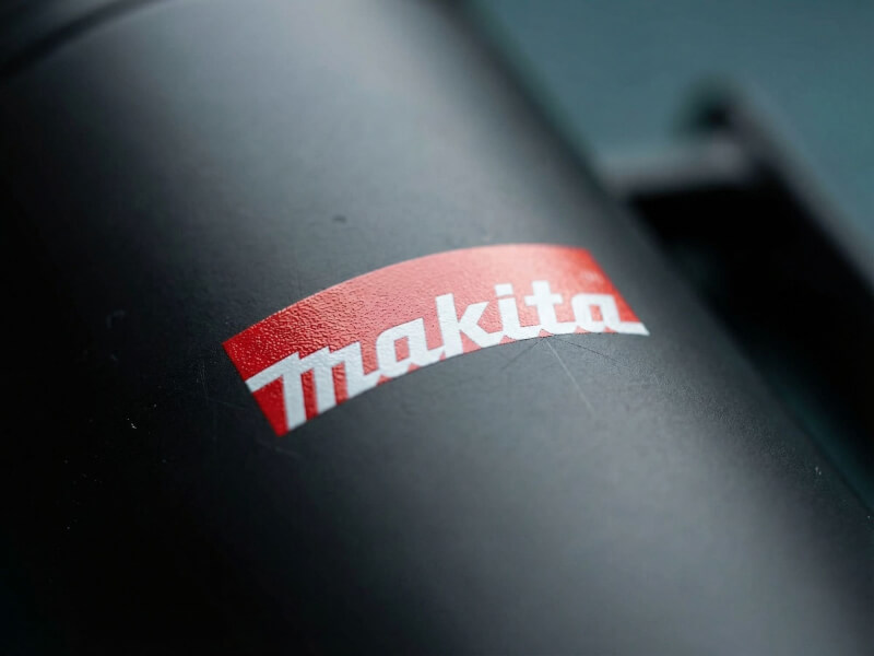 Närbild av en mattsvart termosmugg Clik med en tydlig Makita-logotyp tryckt med tampo- eller UV-tryck.